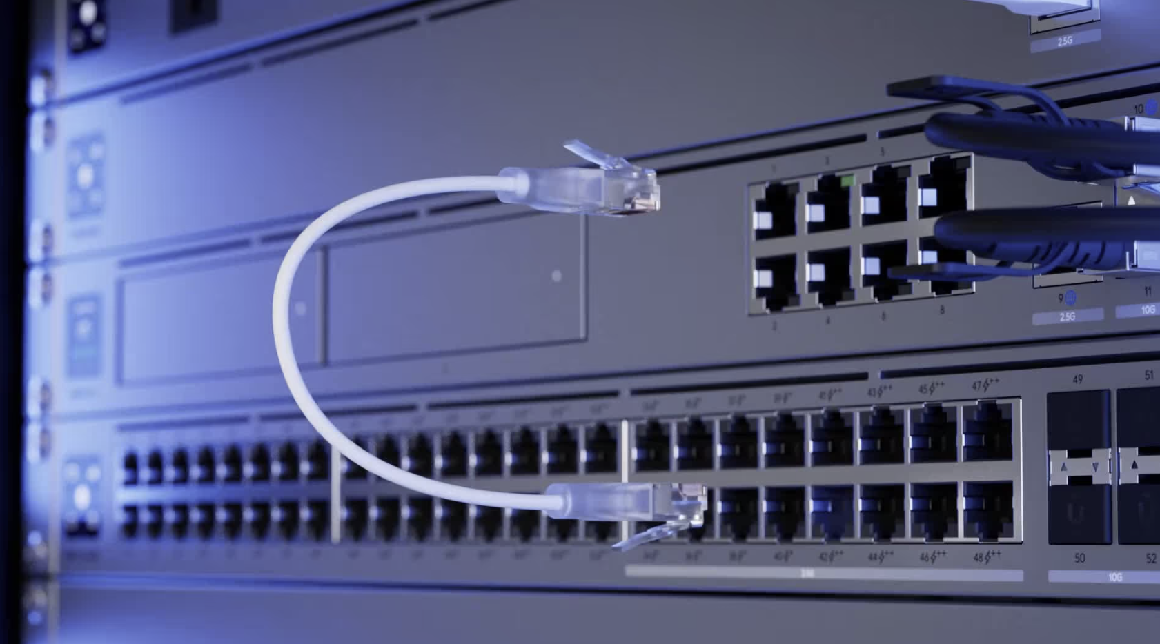 Close-up of a network patch cable connecting two ports on a Ubiquiti switch