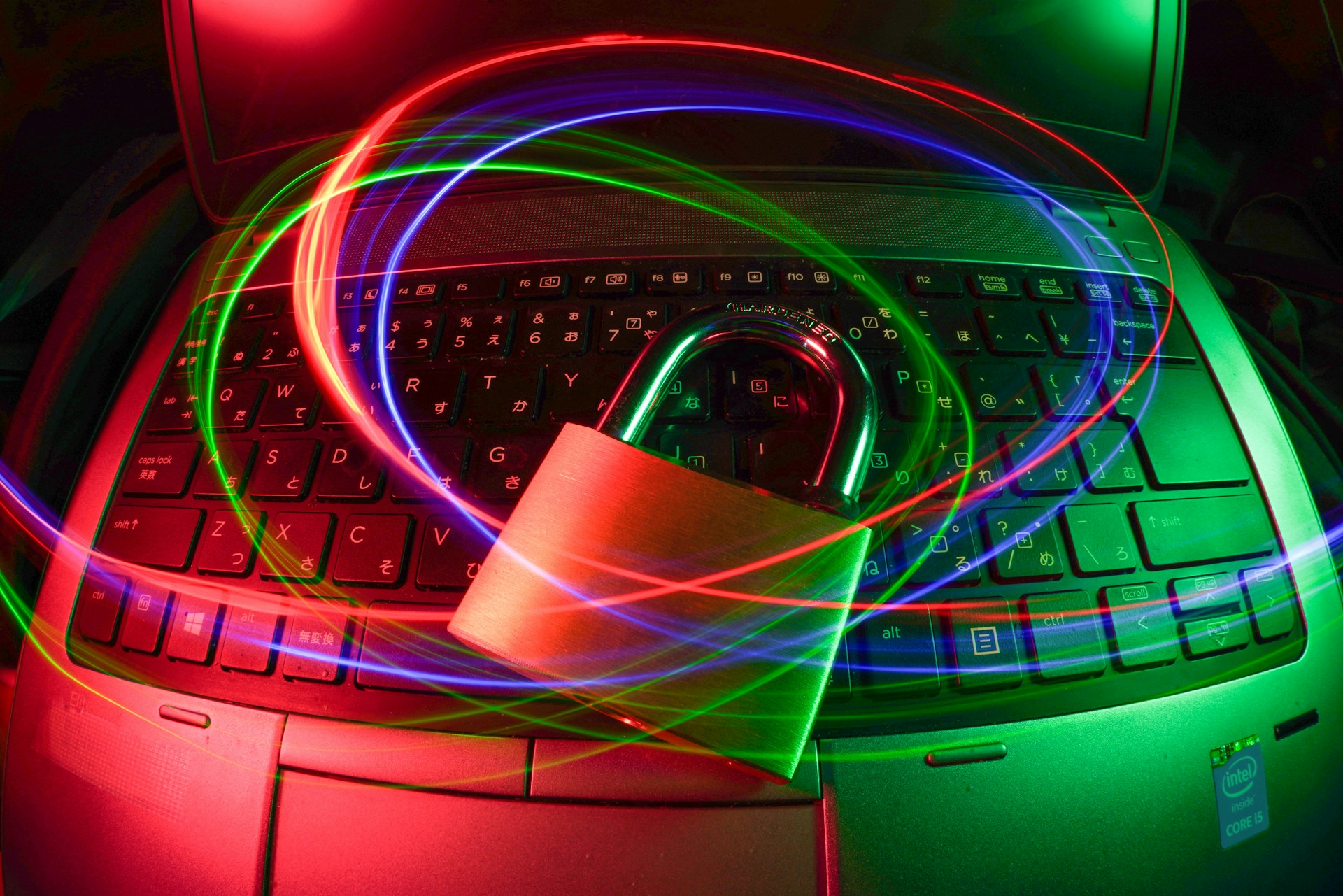 A padlock icon over a laptop keyboard, representing cyber security