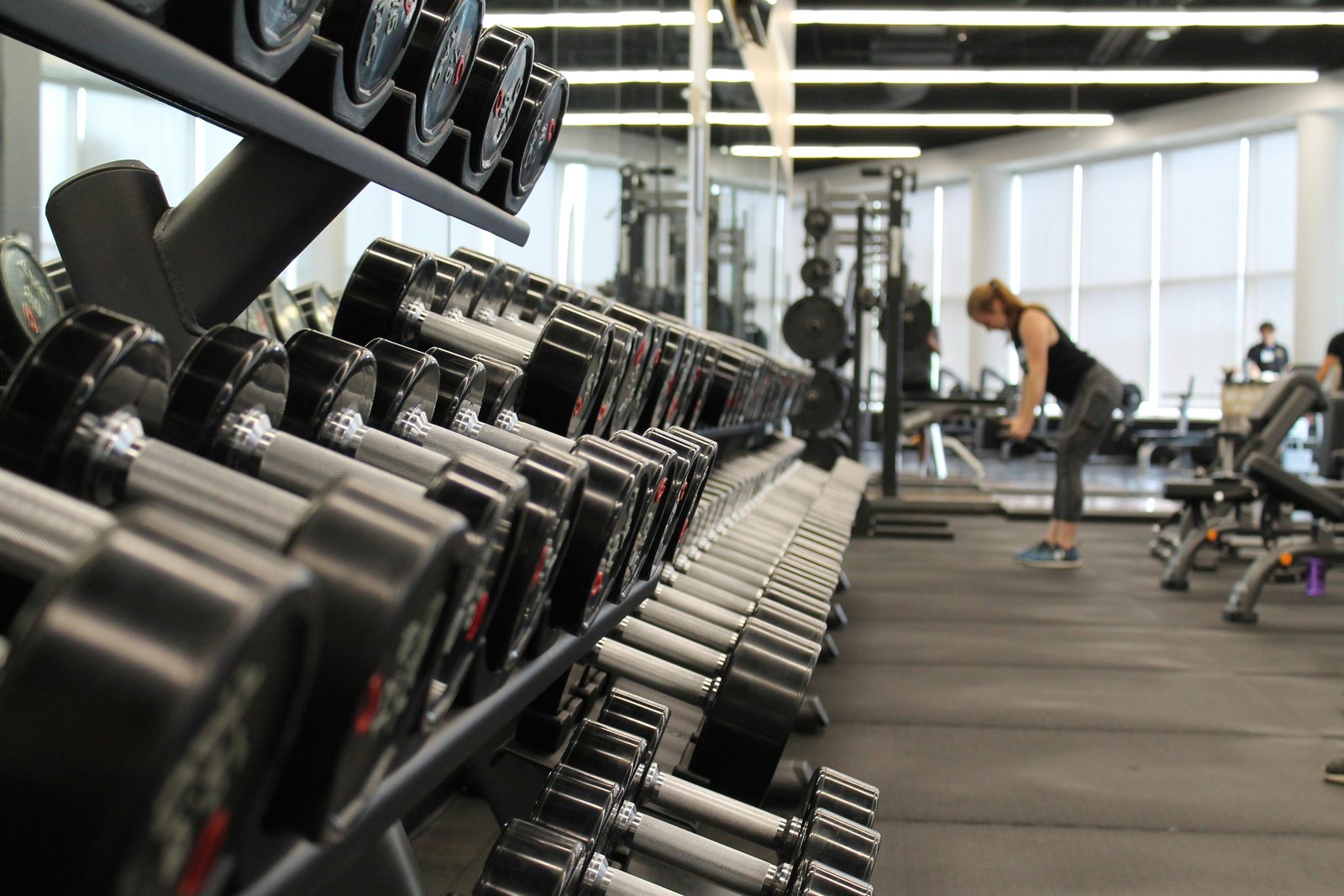 A person standing in a gym surrounded by exercise equipment, the kind of fitness business that runs on a member database of names, contact details and identity documents.